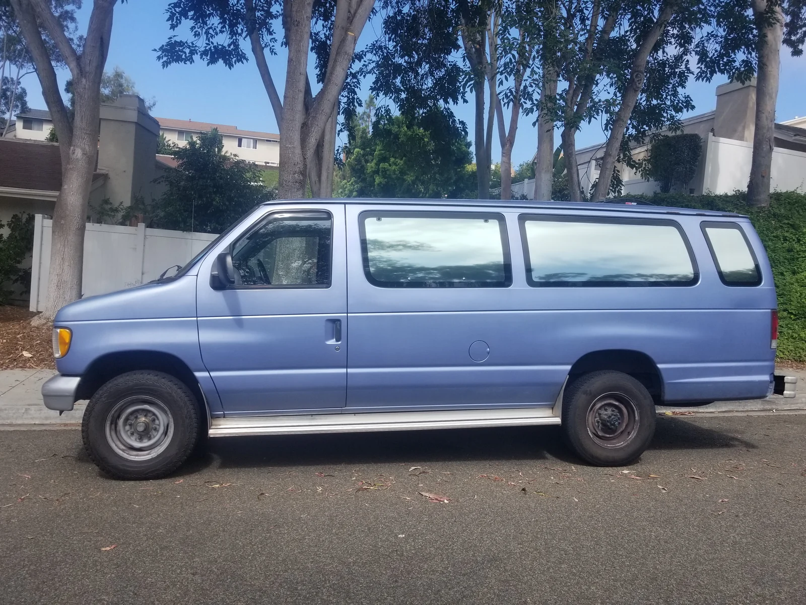 Blue Ford Econoline shown in profile before the green repaint.