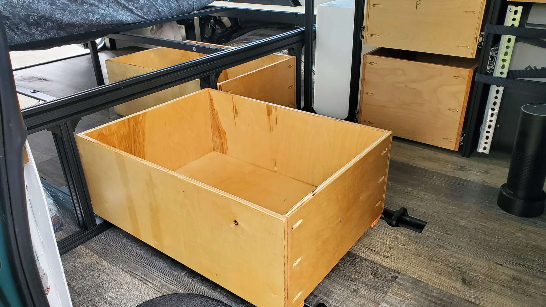 Large open plywood drawer extending into Walter’s aisle, with the second drawer and kitchen nearby.