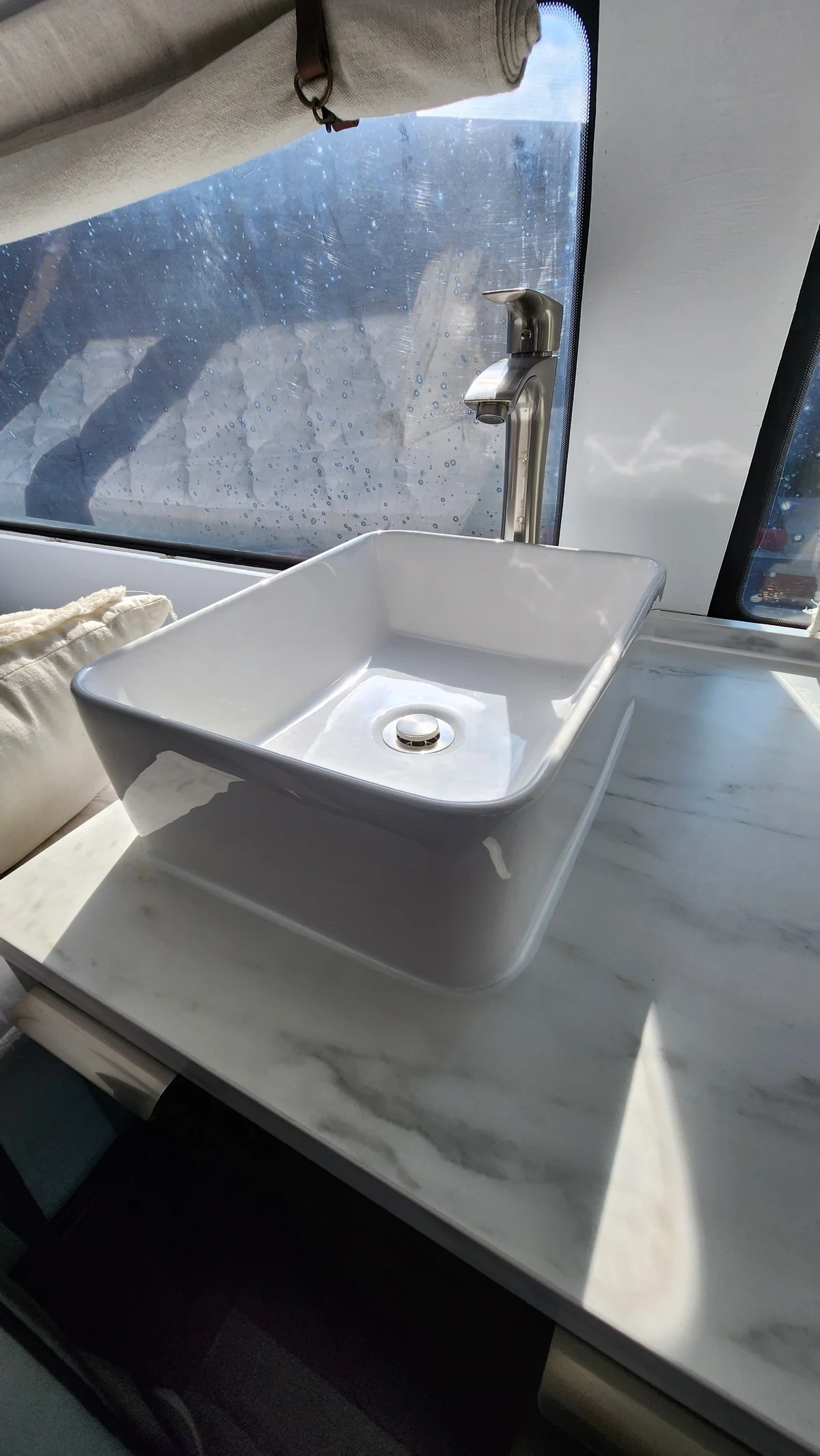 Countertop sink and faucet in the custom campervan kitchenette.