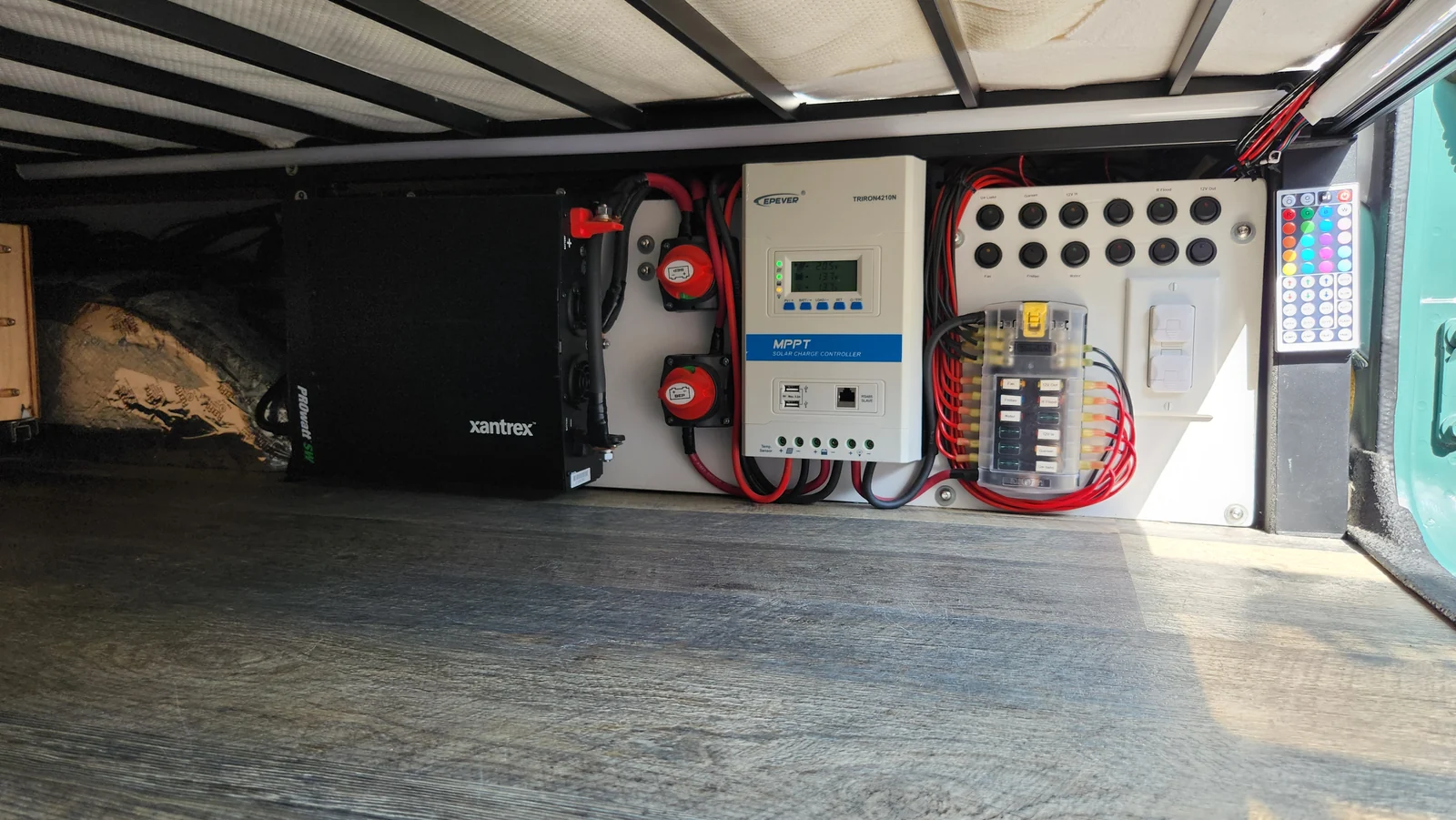 Solar controller, switches, fuse panel and electrical equipment beneath the bed platform.